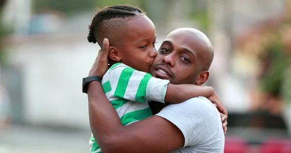 Father and son love and affection. Black African ethnicity. Dad and kid embrace