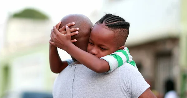 African son hugging father. Black ethnicity family love and affection embrace