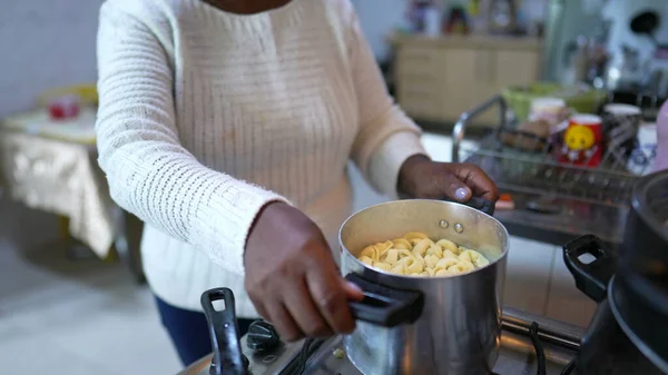 Senior African Woman Cooking Pasta Home Stirring Pot Casual Real — Stockfoto