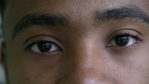 A black man eyes close-up looking at camera an african person macro