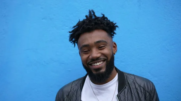 A happy young black man smiling portrait face one charismatic African person