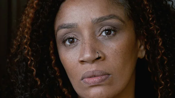 Portrait of a senior black woman face looking at camera an African American person