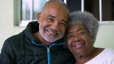 A Brazilian son with elderly mother together smiling