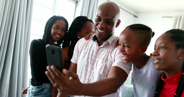African family speaking long distance through smartphone camera
