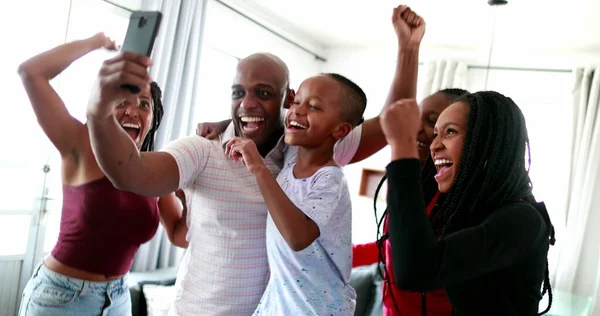 African Family Celebrating Success Cheering Holding Cellphone Device — 스톡 사진