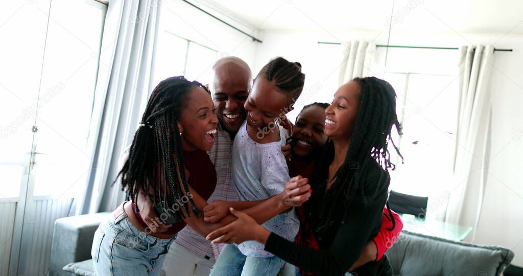 Loving black family embrace. African parents and children hug