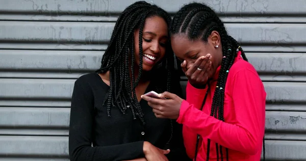 Two Black Girl Friends Laughing Using Smartphone Together — Stockfoto