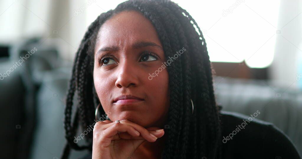 Pensive black teen girl thinking, Thoughtful African mixed race young woman
