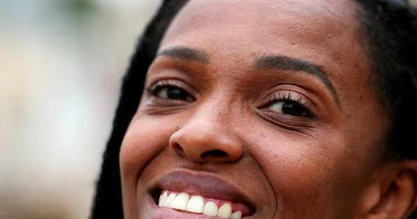 Black African woman close-up face looking at sky feeling happy