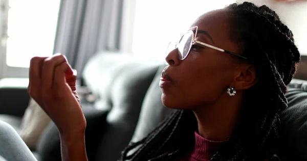 Anxious black woman biting nails