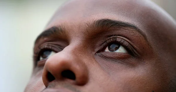 African man opening eyes close-up, black ethnicity person eye open