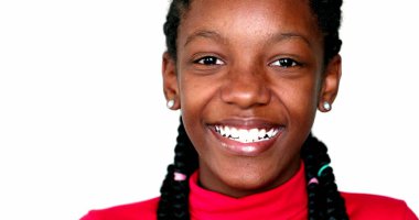 Happy black teen girl smiling and winking to camera. mixed race child