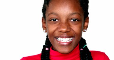 Happy black African teen child girl smiling at camera