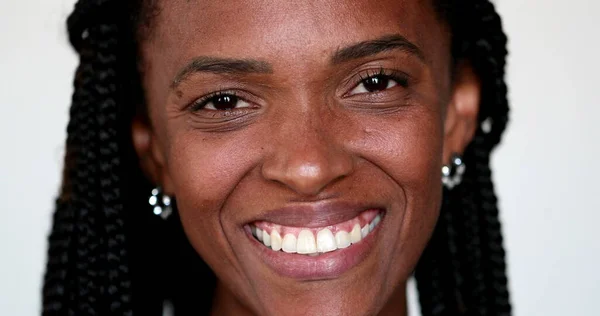 Happy African woman smiling at camera, face portrait, black person