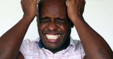Desperate African man close-up emotional stress reaction