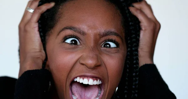 Angry Black teen girl yelling at camera. African woman screaming feeling upset