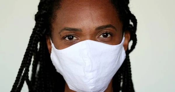 African Woman Putting Face Mask — Stok fotoğraf