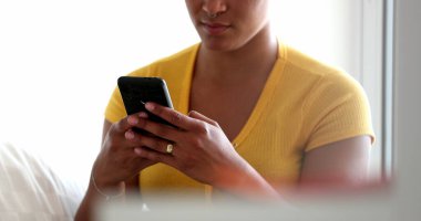African american woman typing text message, black girl reading message on cellphone