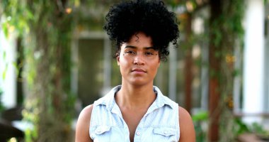 Young African mixed race woman walking forward towards camera