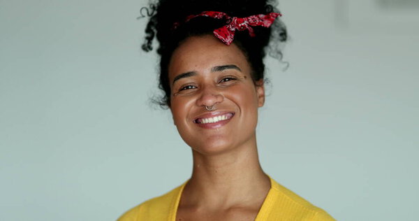 Young millennial mixed race woman smiling at camera