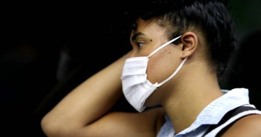 Girl wearing face mask riding subway