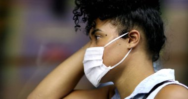 Girl wearing face mask riding subway