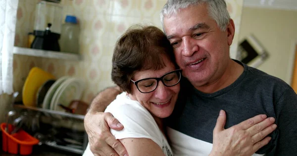 Happy elder wife and husband hugging each other