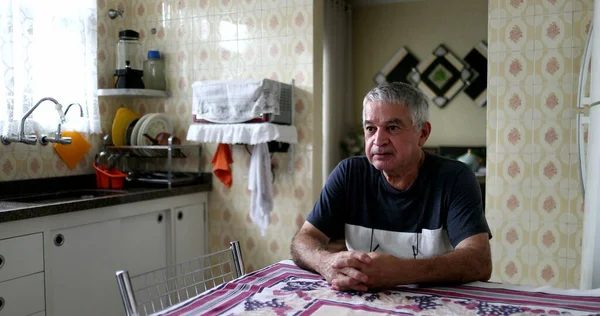 Senior Man Seated Kitchen Table Alone — ストック写真