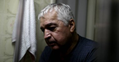 Çaresiz, bunalımdaki yaşlı adam aynaya bakıyor.