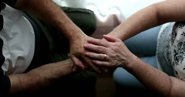 Older people holdings hands in support and empathy