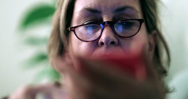 Otantik büyükanne cep telefonu ekranına bakıyor.