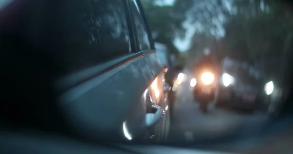 Car side view mirror traffic cars in city