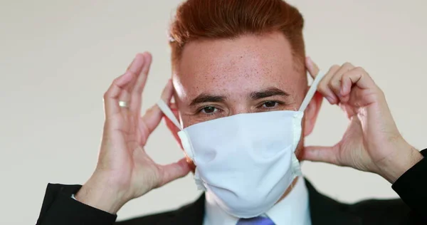 Person removing face mask after pandemic, man feeling relief