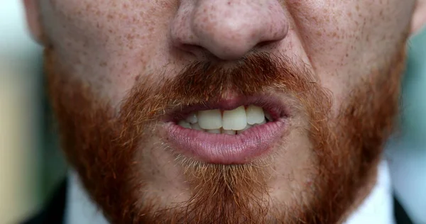 Angry man emotion, close-up person lips and mouth changing mood becoming upset and furious, face portrait redhead