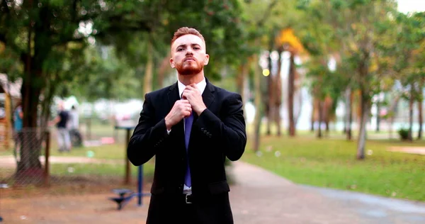 Angry business man standing arguing to camera outside. Upset executive in argument