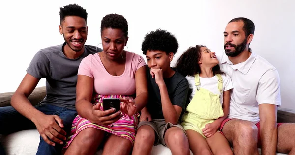 Candid Interracial Parents Looking Smartphone Device Home Couch — ストック写真