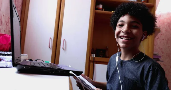 Boy Doing Homework Home Browsing Laptop Writing Notes Looks Camera — Photo