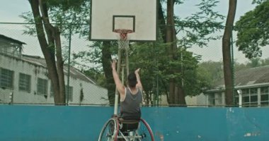 One paraplegic basketball player missing ball hoop outside. Determination disability concept
