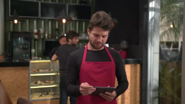 One Male Barista Looking Tablet Device Standing Local Business Coffee — Vídeo de stock