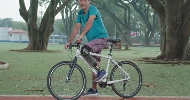 One Disabled Person Prosthetic Leg Standing Park Bike Looking Camera — kuvapankkivideo