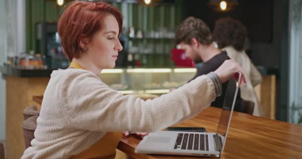 Young Female Employee Opening Laptop Computer Sitting Coffee Shop Wearing — Vídeos de Stock
