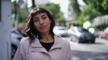 One Brazilian latina woman standing in urban street walking