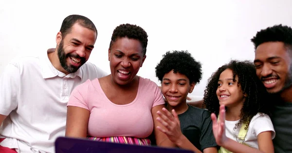 Happy African family talking to relatives on laptop computer