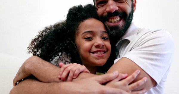 Father embracing daughter child. Interracial parent and child relationship