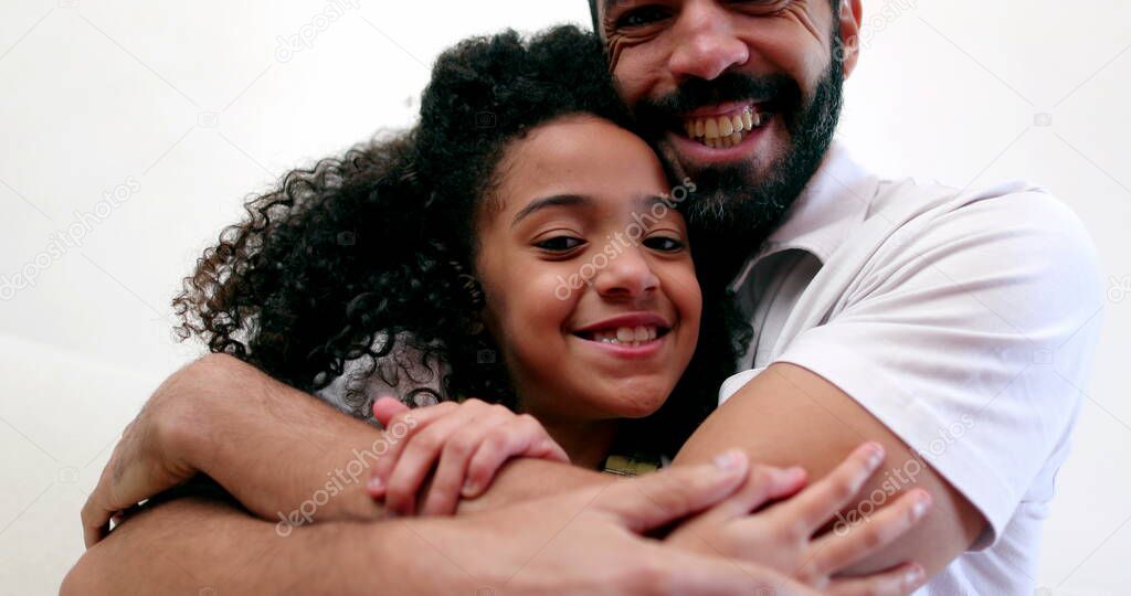 Father embracing daughter child. Interracial parent and child relationship