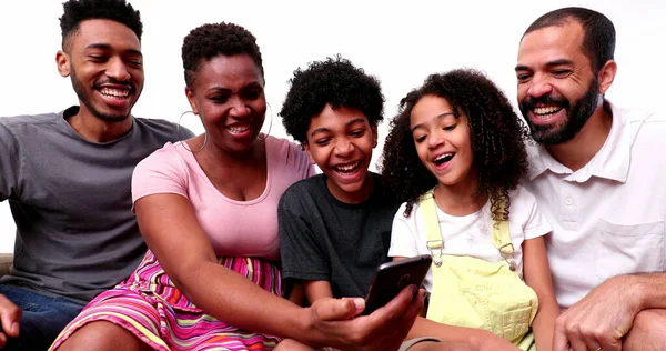 Happy Mixed Race Family Looking Phone Device Laughing Smiling — Stockfoto