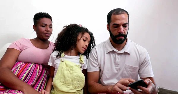 Multiracial Parents Child Looking Cellphone — 스톡 사진