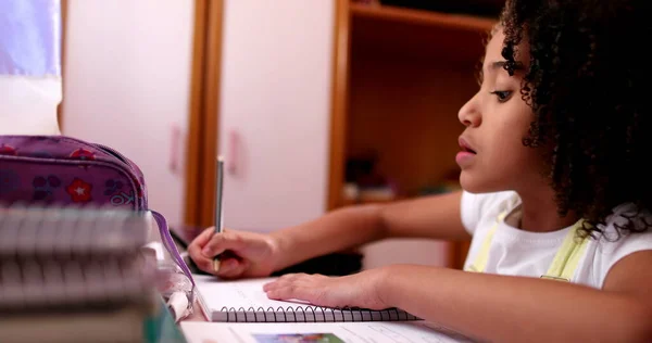 Smart Concentrated Little School Girl Doing Homework Writing Notes — Fotografia de Stock