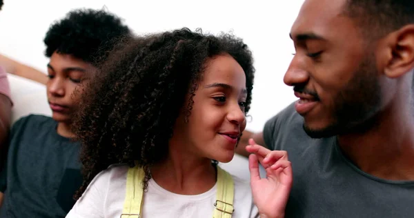 Siblings love care and affection. Older brother kissing little sister on cheek, mixed race ethnicity