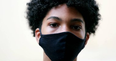 Young boy wearing covid face mask, mixed race ethnicity